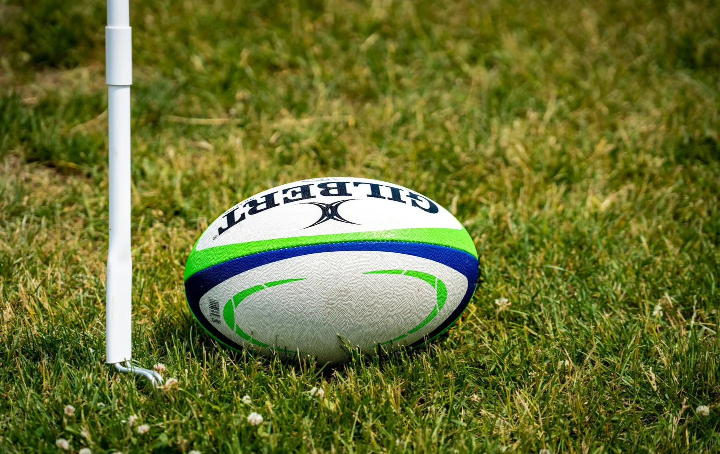 A rugby ball on a kicking tee near the corner flag
